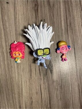 collection of small plastic figurines from the Trolls World Tour happy meal 2020